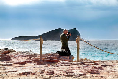 Man standing on beach against sky