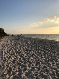 Scenic view of beach against sky during sunset