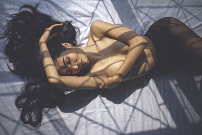 High angle view of woman lying on bed
