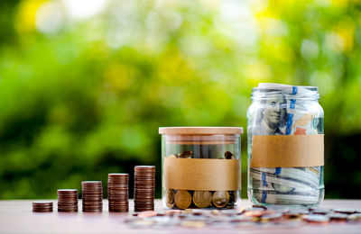 Close-up of coins in jar on table