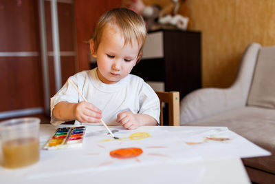 Boy painting with watercolors