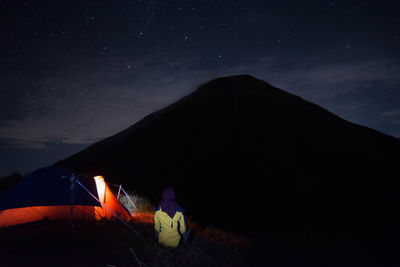 Scenic view of illuminated mountain against sky at night