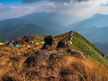 High angle view of tents over grass against mountains and sky