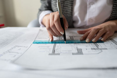 Cropped architect making draft in workplace