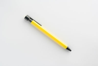 High angle view of colored pencils on white background