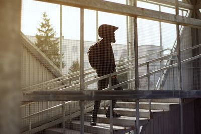 Side view of man walking on staircase