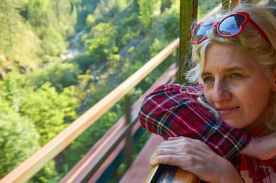 Woman leaned out off a train window and watching out while traveling