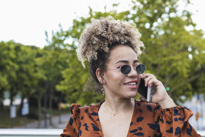 Portrait of young man using smart phone outdoors