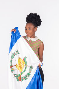 Portrait of woman standing against white background