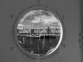 Ships moored in sae seen through window