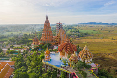 Panoramic view of temple by building against sky