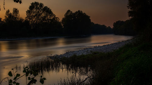 Scenic view of lake against sky at sunset