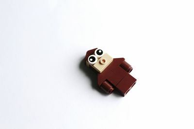 Close-up of toy on table against white background