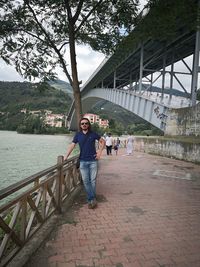 Portrait of woman standing on footbridge