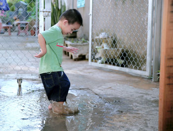 Boy enjoying in puddle