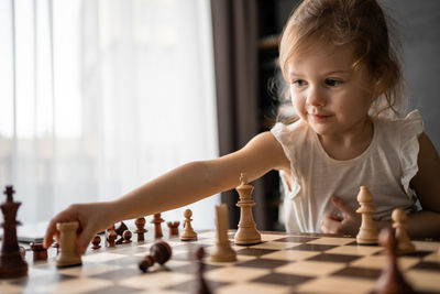 Mother playing with toy blocks at home