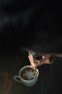 Person holding coffee cup on table