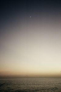 Scenic view of sea against clear sky at dusk
