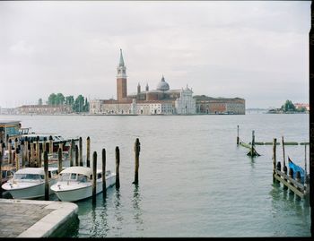 View of buildings at waterfront against sky