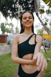 Portrait of young woman standing in park