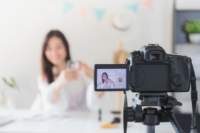 Portrait of woman photographing