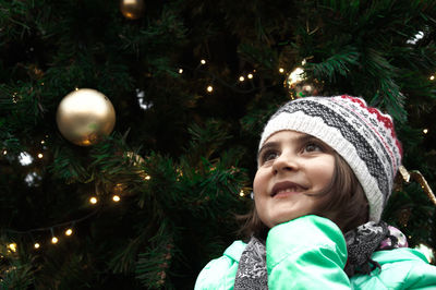 Close-up of girl with christmas tree