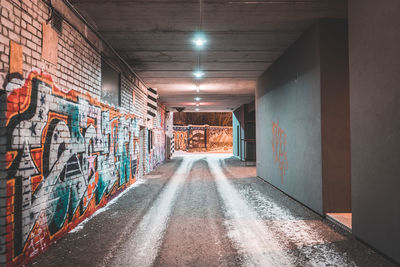 Graffiti on illuminated walkway