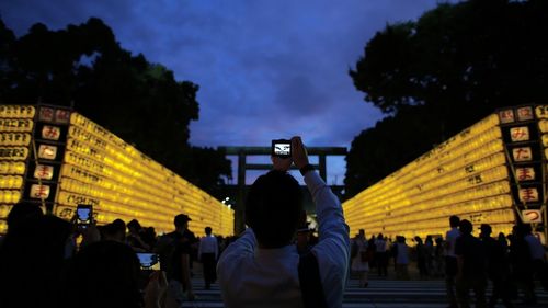 People in illuminated park at night