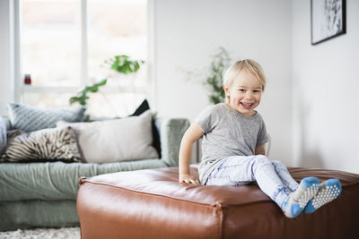 Boy playing on sofa