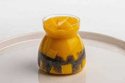 Close-up of yellow glass on table