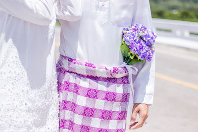 Midsection of couple during wedding ceremony