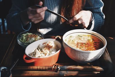 Midsection of man eating food