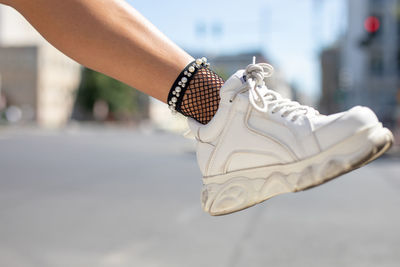 Low section of woman on road