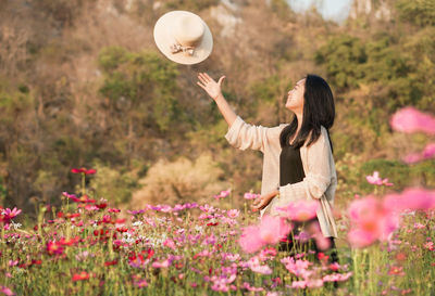 Rear view of woman standing by plants