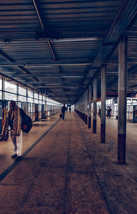 People walking on railroad station platform