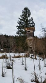 Built structure on snow field against sky