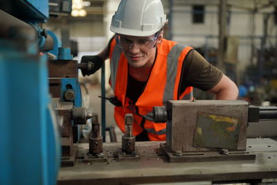 Portrait of male worker standing in the heavy industry manufacturing factory.