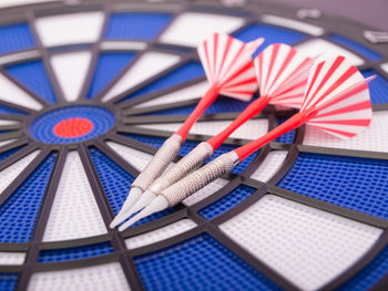 Close-up of darts on dartboard