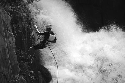 Man climbing on rope