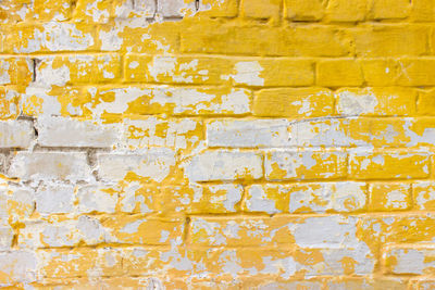 Background of old vintage dirty brick wall with peeling plaster. background or texture.