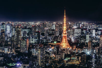 Aerial view of illuminated buildings in city at night