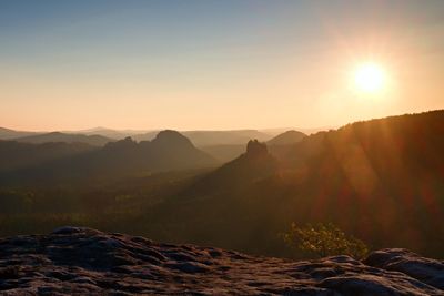 Scenic view of mountains against sky during sunset