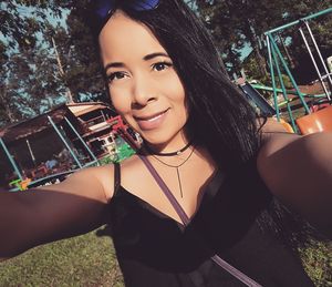 Close-up of young woman standing at park