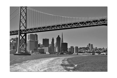 View of suspension bridge with city in background