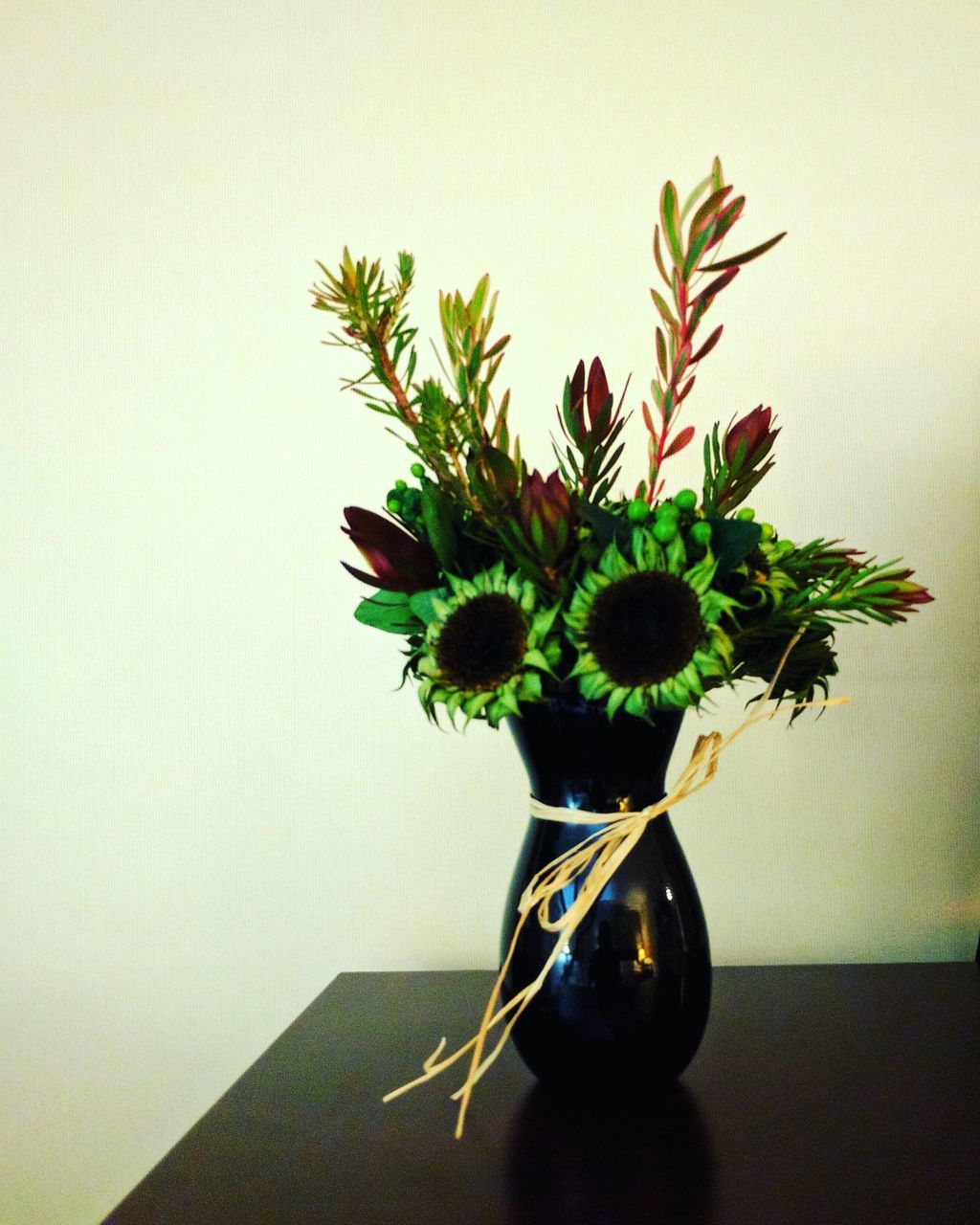 CLOSE-UP OF FLOWER ON TABLE