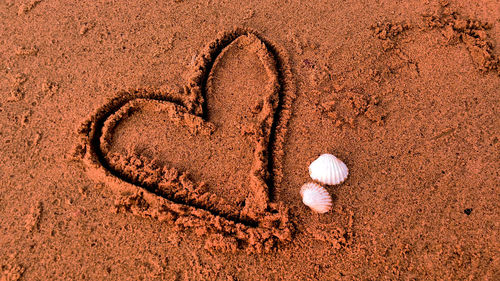 High angle view of heart shape on sand