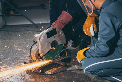 Low angle view of man working on metal