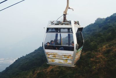 Overhead cable car on mountain against sky