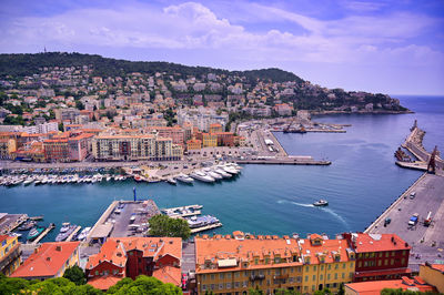 High angle view of townscape by sea against sky