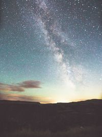 Scenic view of landscape against sky at night